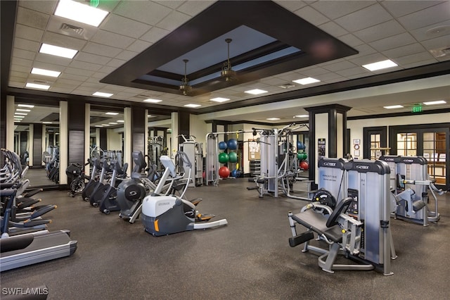 exercise room featuring a paneled ceiling and a tray ceiling