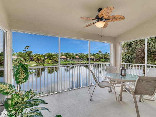 sunroom with a water view, ceiling fan, and vaulted ceiling