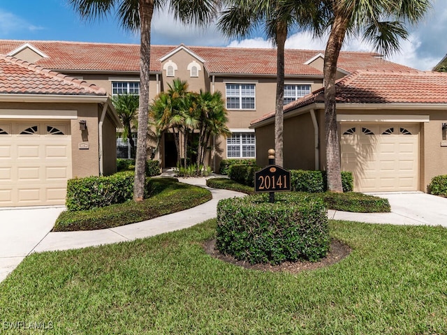 view of front of house featuring a garage and a front lawn