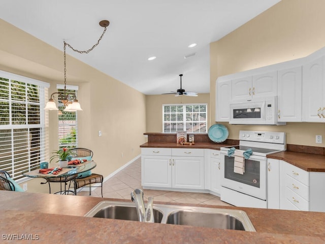 kitchen featuring ceiling fan with notable chandelier, white cabinets, pendant lighting, and white appliances