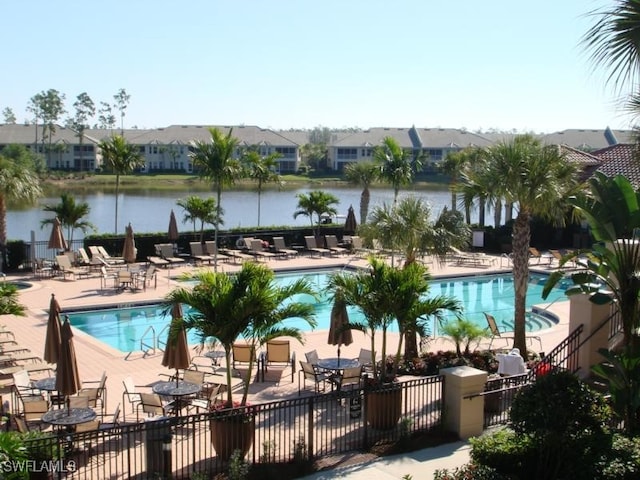 view of pool featuring a patio area and a water view