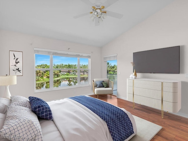 bedroom with hardwood / wood-style flooring, ceiling fan, and lofted ceiling