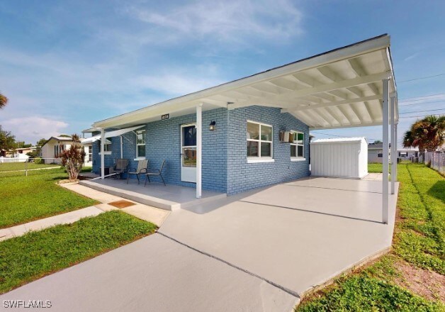 exterior space featuring a front lawn and a carport