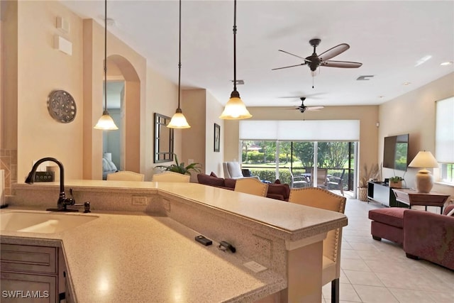 kitchen featuring sink, plenty of natural light, light tile patterned flooring, and ceiling fan