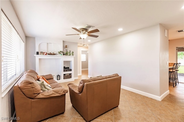 tiled living room with ceiling fan