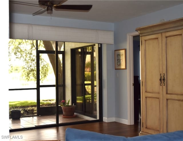 doorway with hardwood / wood-style flooring and ceiling fan