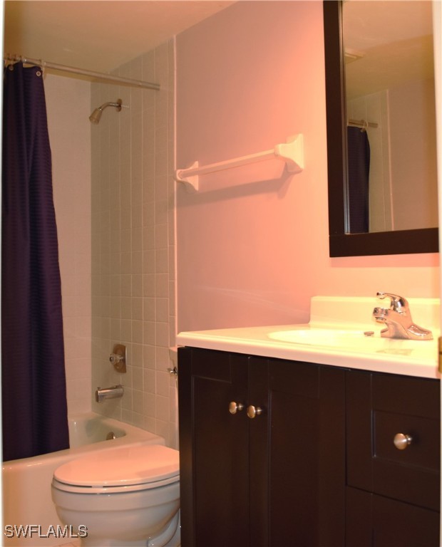 full bathroom with vanity, toilet, and shower / bath combo with shower curtain