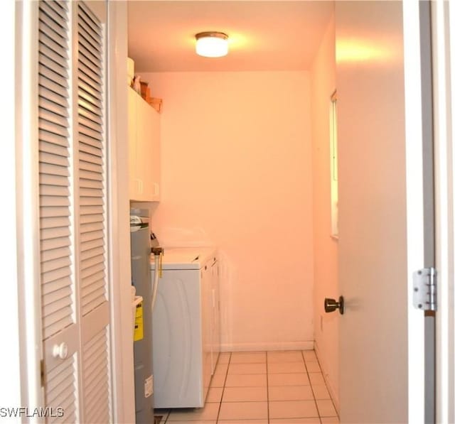 7125 Lakeridge Ct Unit 118, Fort Myers, FL 33907 - laundry area with washer and dryer, light tile patterned floors, cabinet space, and baseboards