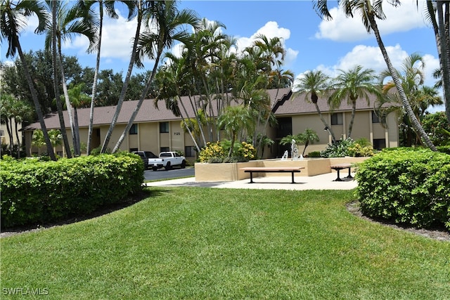 view of property's community with a lawn