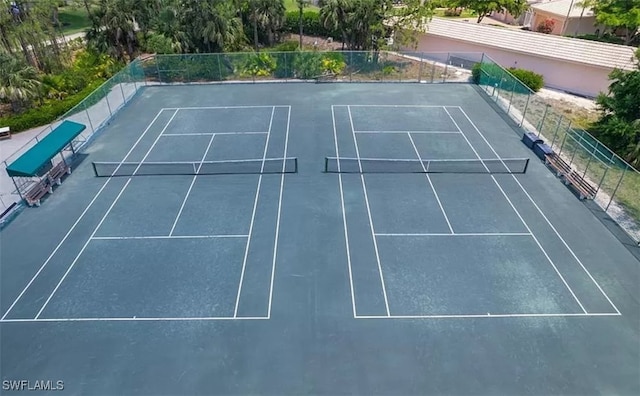 view of tennis court featuring fence