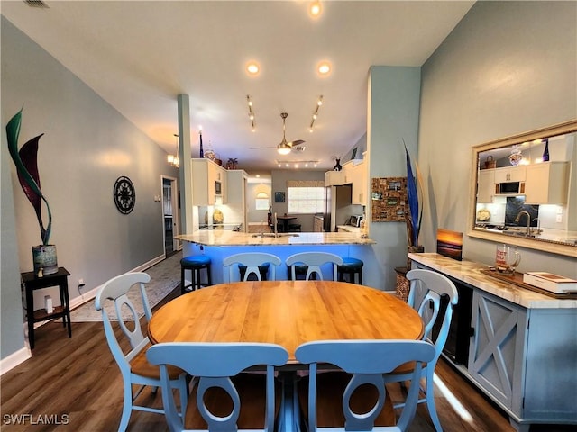 dining room featuring ceiling fan, dark wood finished floors, and baseboards