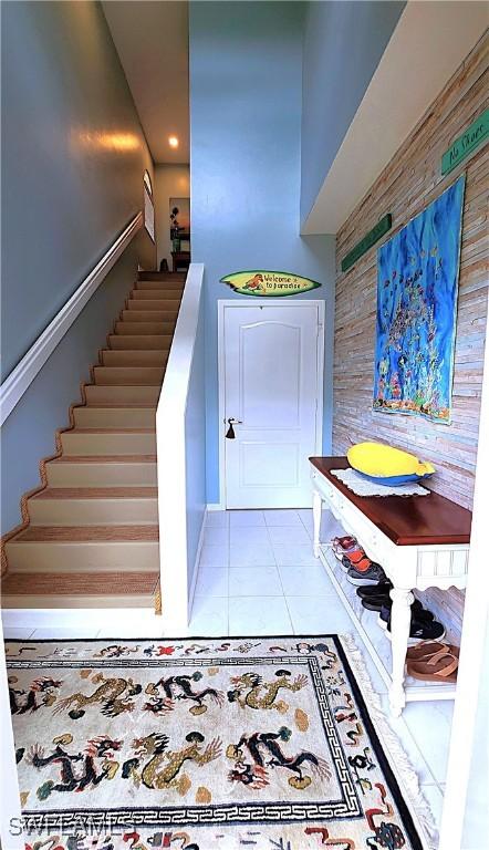 interior space featuring stairs and light tile patterned flooring