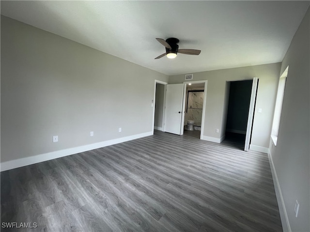 unfurnished bedroom with hardwood / wood-style flooring, connected bathroom, and ceiling fan