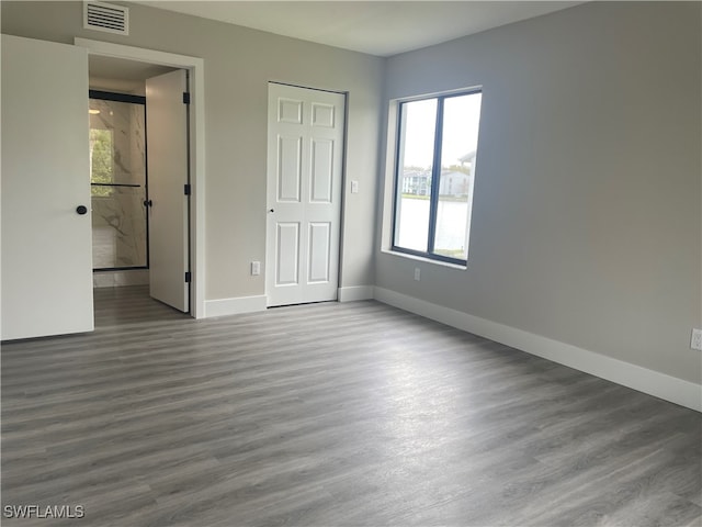 unfurnished bedroom with hardwood / wood-style flooring