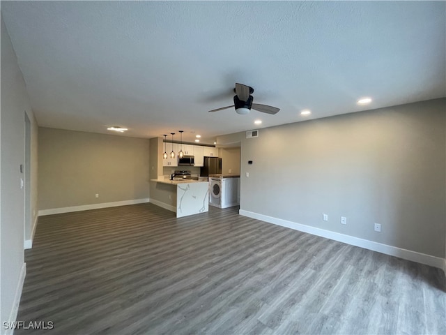 unfurnished living room with hardwood / wood-style flooring and ceiling fan