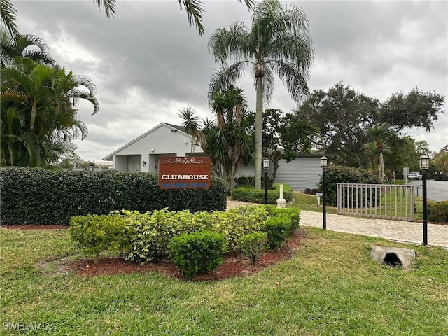 community / neighborhood sign with a yard