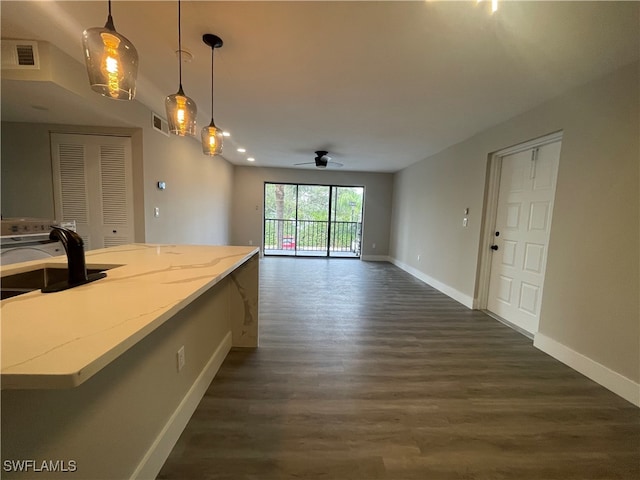 kitchen with sink, dark hardwood / wood-style flooring, pendant lighting, and ceiling fan