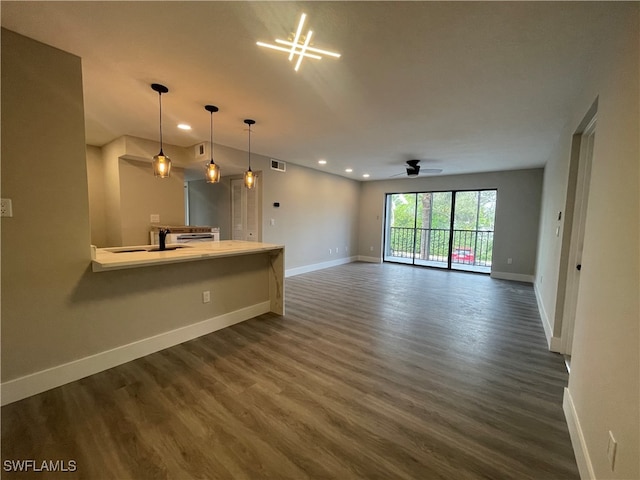 unfurnished living room with sink, dark wood-type flooring, and ceiling fan