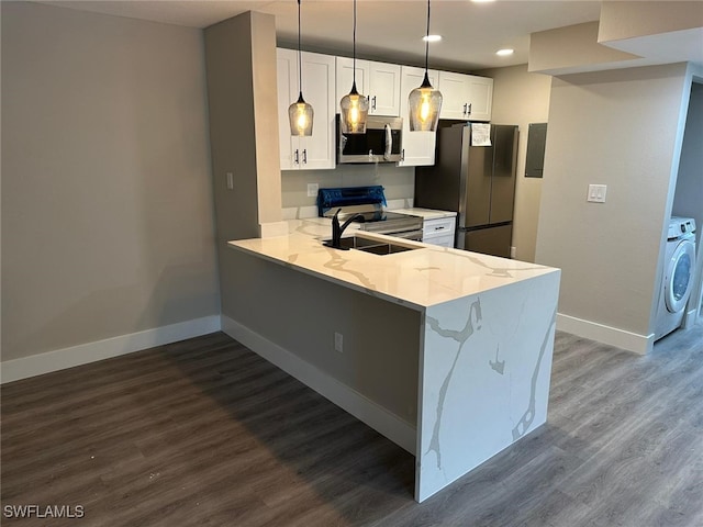 kitchen with white cabinetry, kitchen peninsula, stainless steel appliances, light stone countertops, and hardwood / wood-style floors