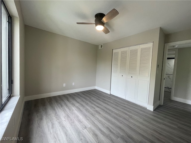 unfurnished bedroom featuring hardwood / wood-style flooring, a closet, and ceiling fan