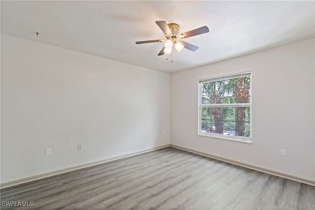 unfurnished room featuring light hardwood / wood-style floors and ceiling fan