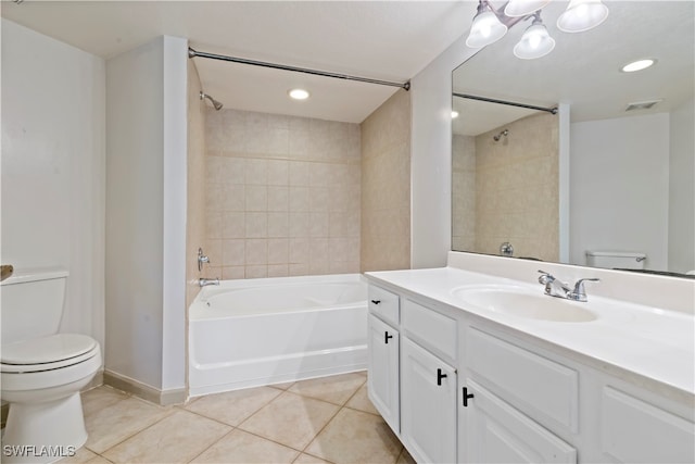 full bathroom featuring vanity, tiled shower / bath combo, toilet, and tile patterned floors