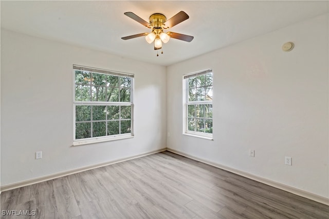 spare room with light wood-type flooring and ceiling fan