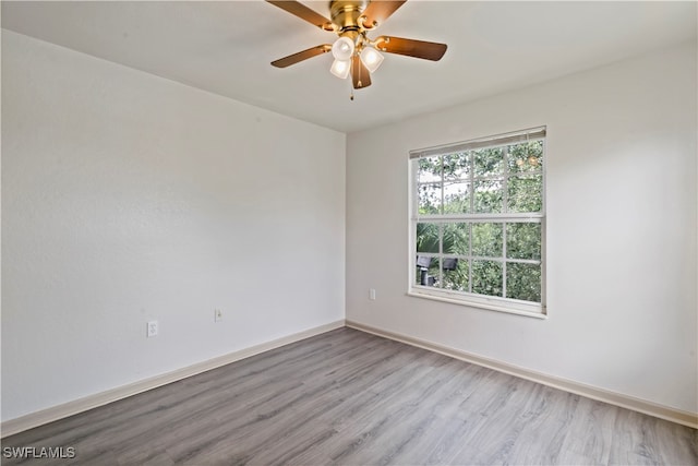 spare room with light wood-type flooring and ceiling fan