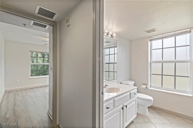 bathroom with vanity, tile patterned floors, a textured ceiling, and toilet