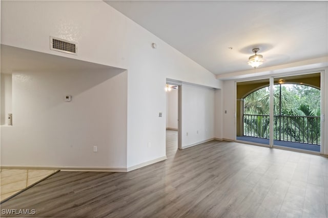 spare room featuring vaulted ceiling, ceiling fan, and hardwood / wood-style floors