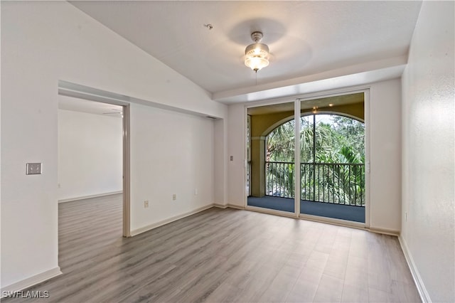 spare room featuring lofted ceiling, ceiling fan, and hardwood / wood-style floors