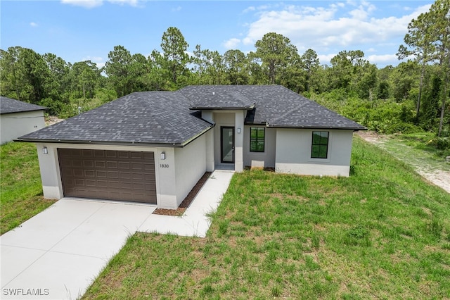 view of front of house with a front lawn and a garage