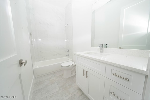 full bathroom featuring vanity, tiled shower / bath combo, and toilet