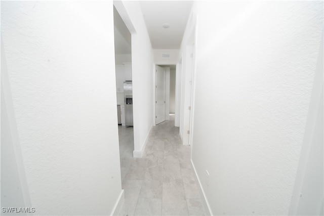 corridor with light hardwood / wood-style floors