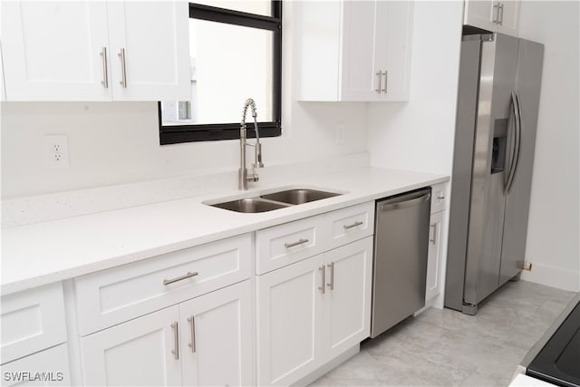 kitchen featuring white cabinets, appliances with stainless steel finishes, and sink