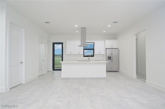 kitchen with island range hood, white cabinetry, light countertops, stainless steel refrigerator with ice dispenser, and a center island