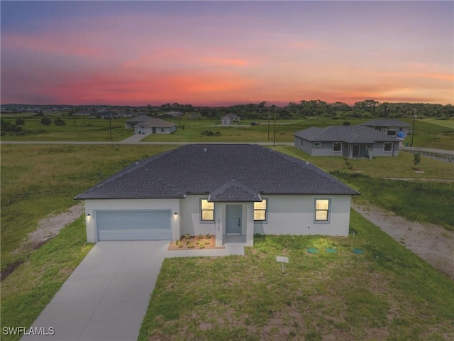 view of front of property featuring a lawn and a garage