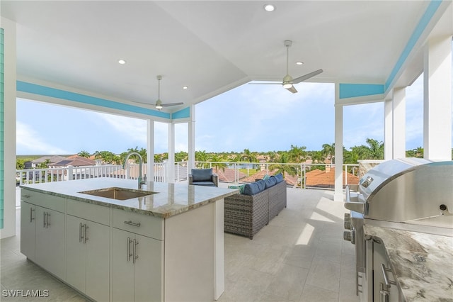 view of patio / terrace featuring an outdoor kitchen, sink, outdoor lounge area, and ceiling fan