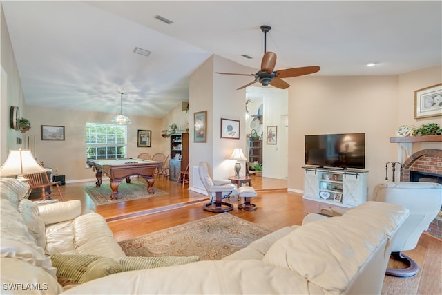 living room featuring light hardwood / wood-style flooring, lofted ceiling, billiards, and a fireplace