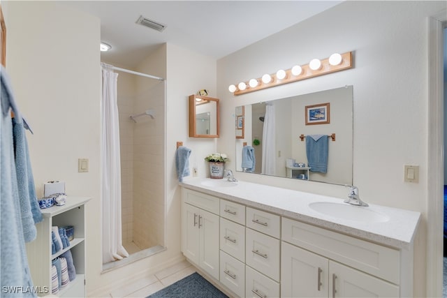 bathroom featuring vanity, tile patterned flooring, and walk in shower