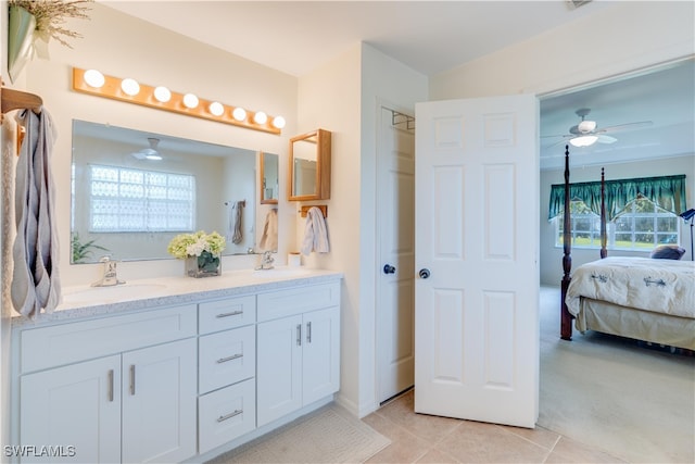 bathroom featuring vanity, a healthy amount of sunlight, ceiling fan, and tile patterned flooring