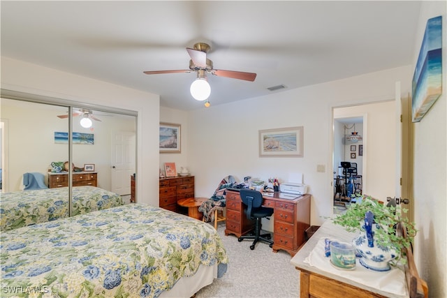 carpeted bedroom featuring a closet and ceiling fan