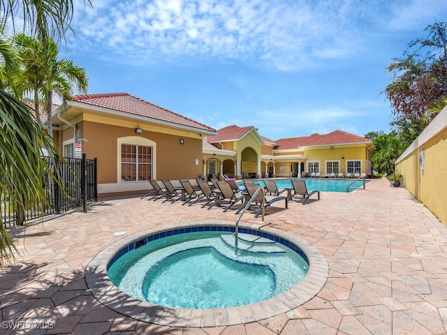 view of pool featuring a community hot tub and a patio