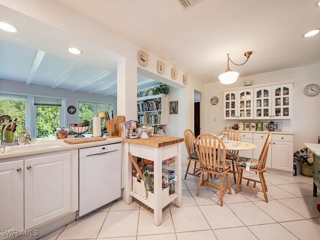 kitchen with light tile patterned floors, white cabinets, and dishwasher