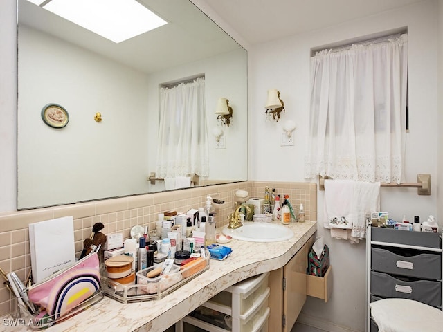 bathroom with decorative backsplash and vanity