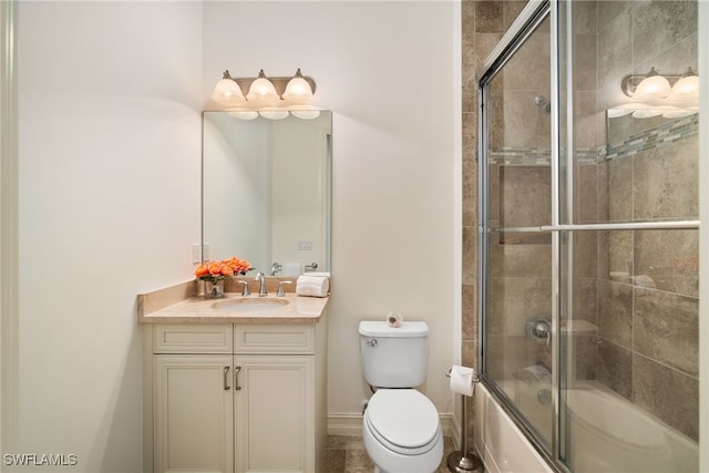 full bathroom with shower / bath combination with glass door, vanity, and toilet