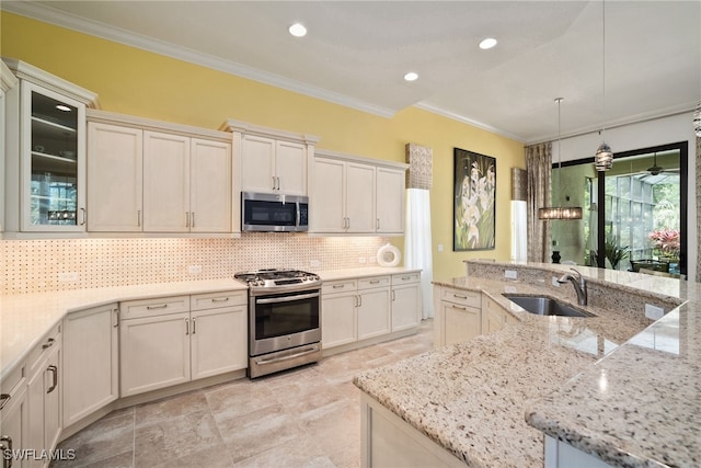 kitchen with stainless steel appliances, sink, tasteful backsplash, light stone countertops, and pendant lighting