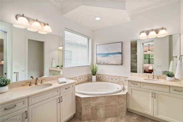 bathroom featuring crown molding, a wealth of natural light, vanity, and a relaxing tiled tub