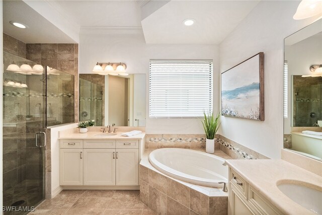 bathroom with plus walk in shower, ornamental molding, and vanity