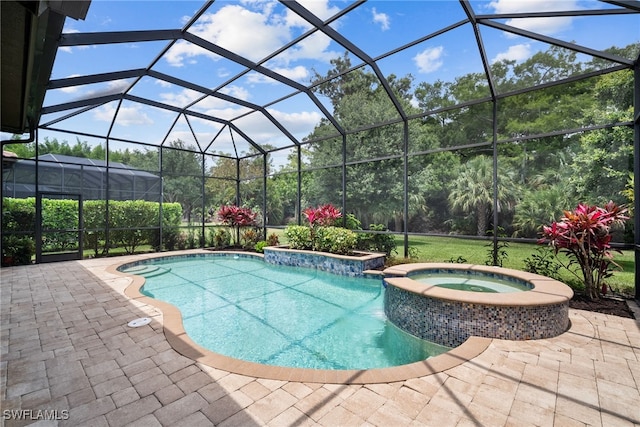 view of swimming pool featuring a patio area, a lanai, and an in ground hot tub